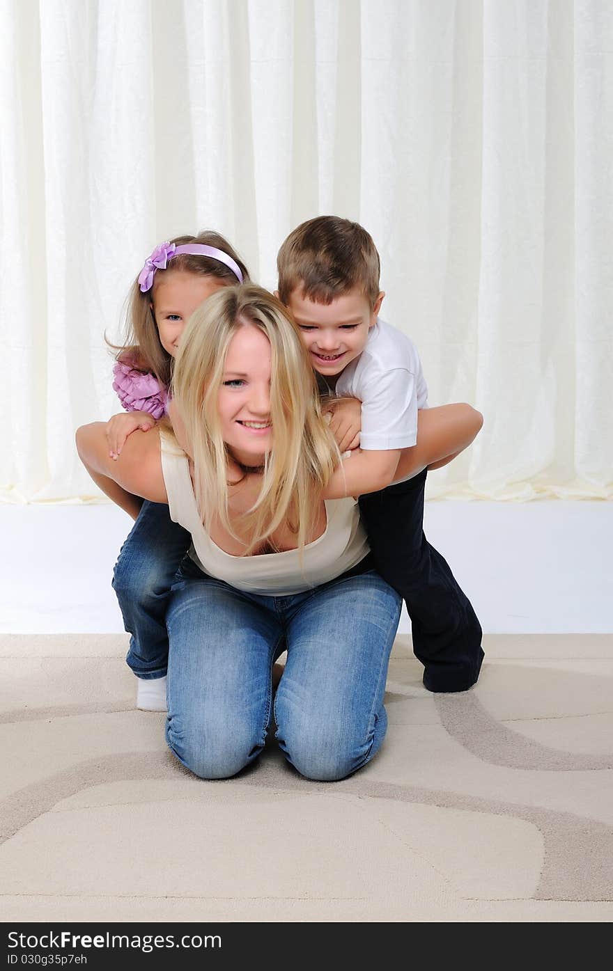 A young mother, her daughter and son having fun together