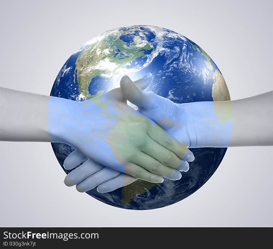 Business handshake on the background of the Earth. The symbol of a successful business.