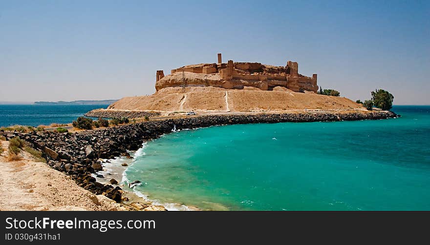 Syrian castle Qalat Jabar surrounded by water of Asad lake.