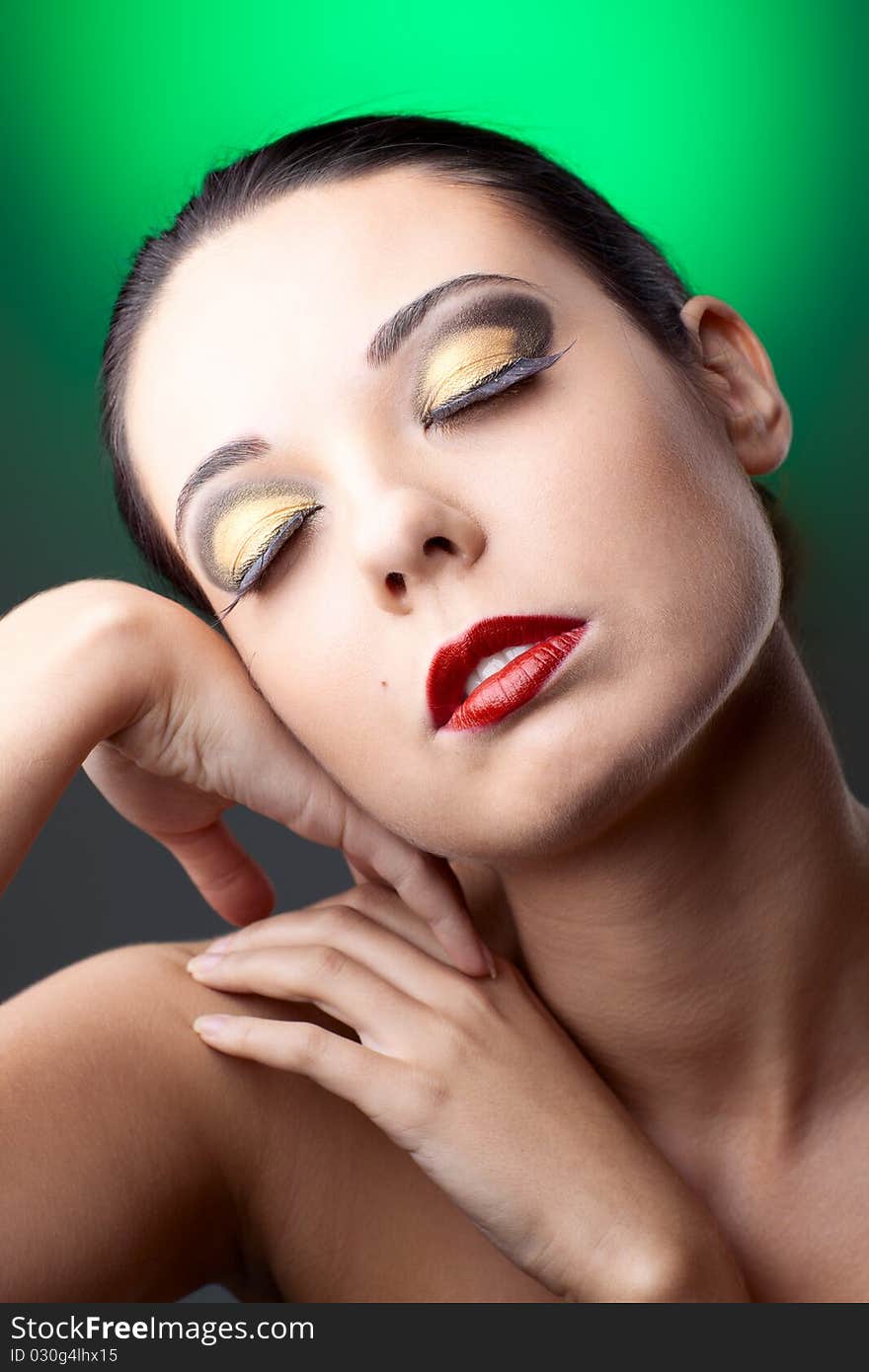 Beautiful woman over color background with beautiful makeup