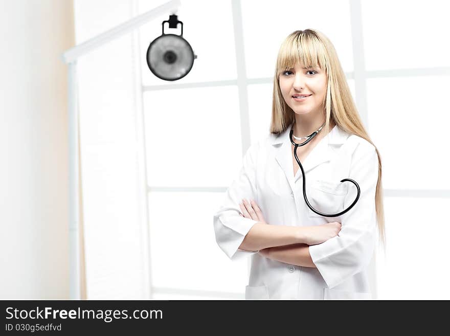 Woman doctor with blond hair in white. Woman doctor with blond hair in white