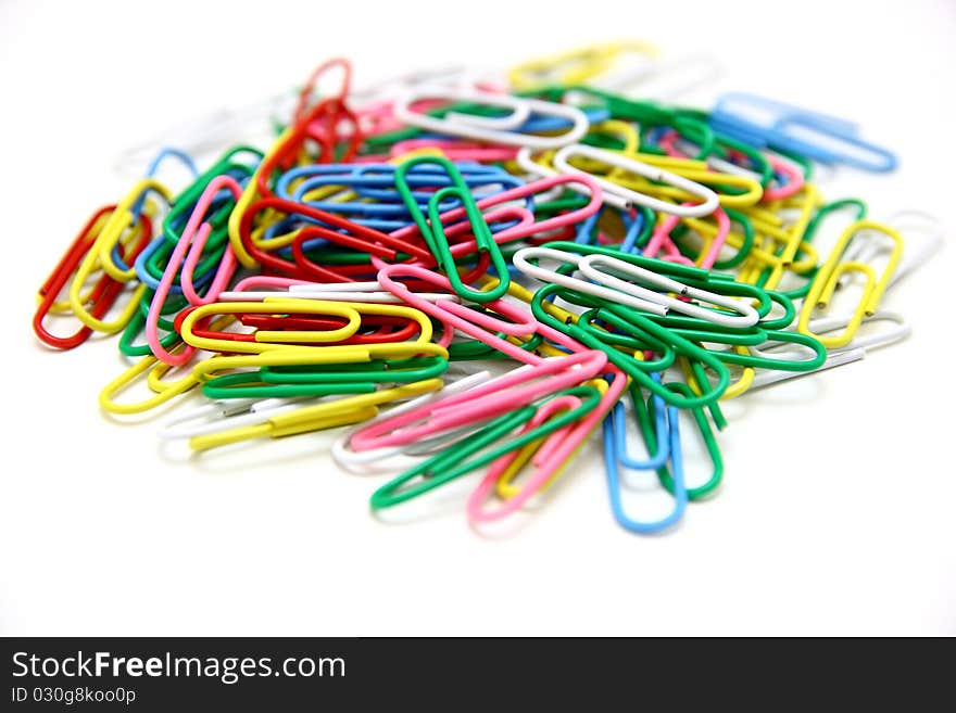 Color paper clips to background. Isolated on white background