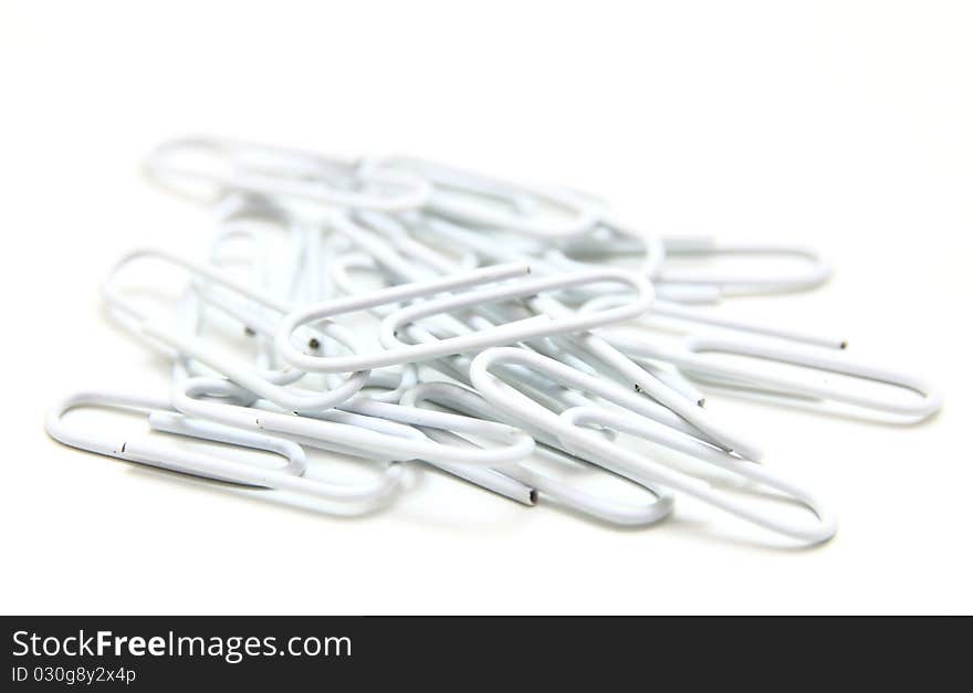 Color paper clips to background. Isolated on white background