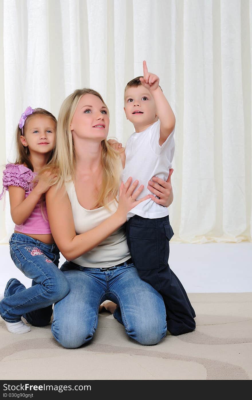 A young mother, her daughter and son having fun together