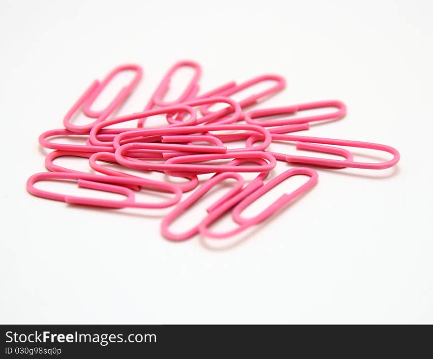 Color paper clips to background. Isolated on white background