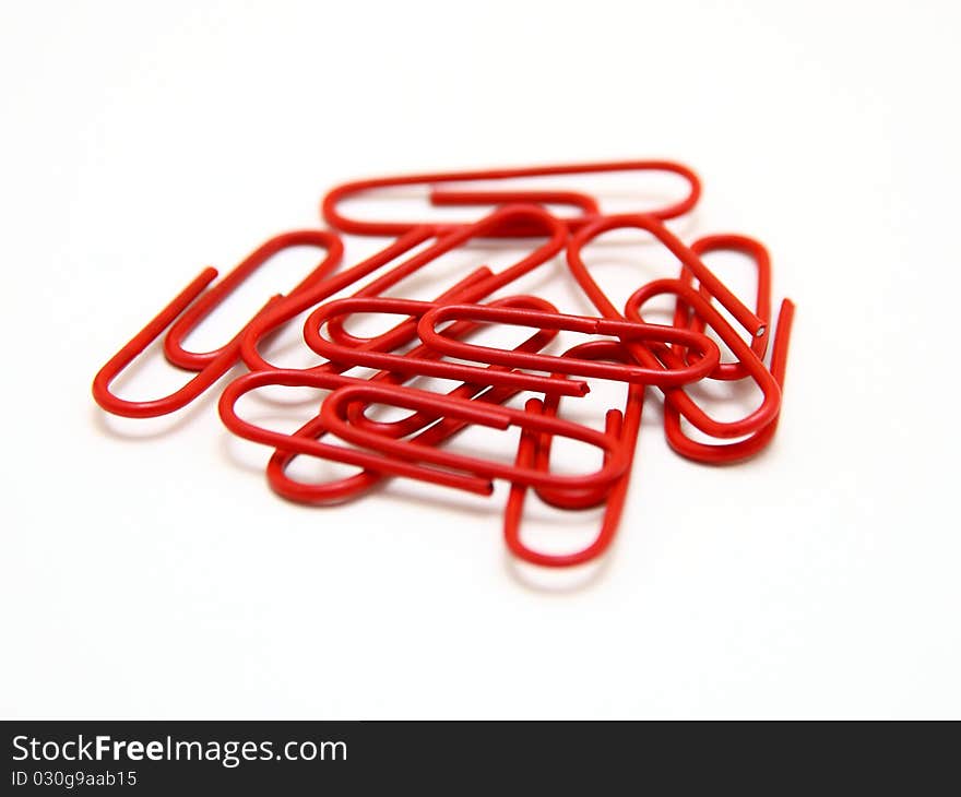 Color paper clips to background. Isolated on white background