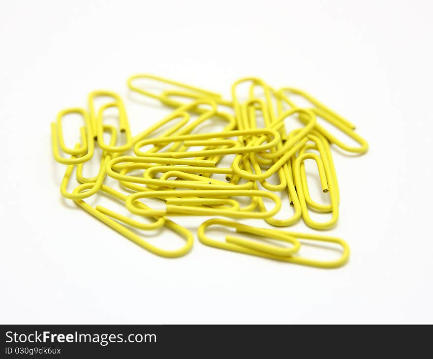 Color paper clips to background. Isolated on white background