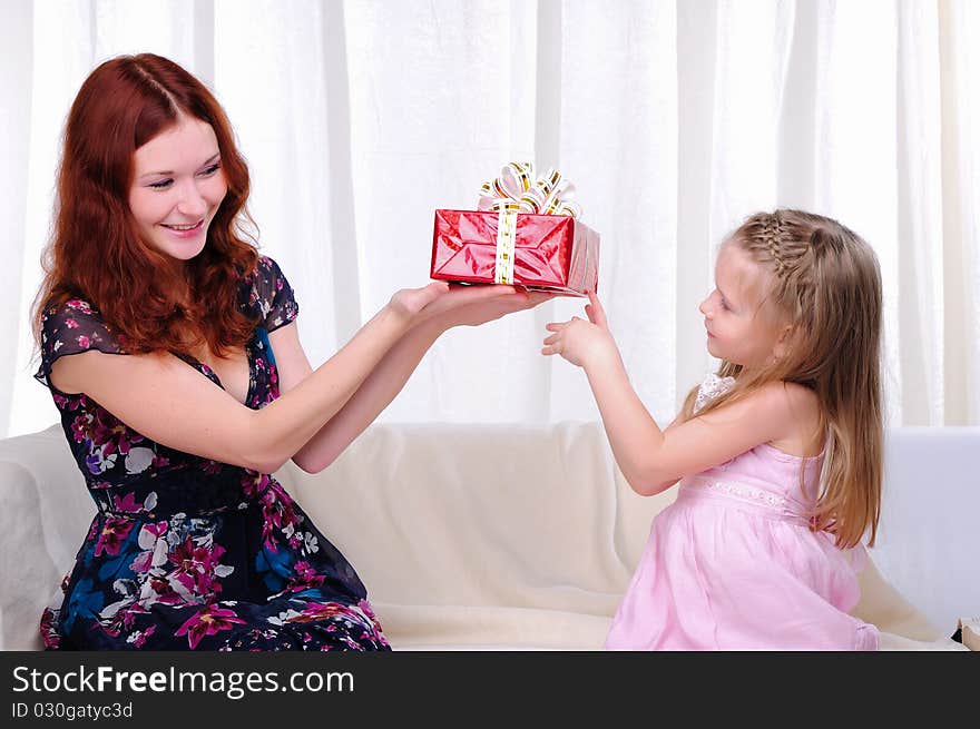 Little girl mom gives a holiday gift