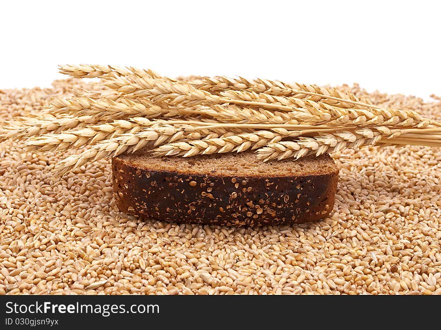 Slice bread with wheat ears on white