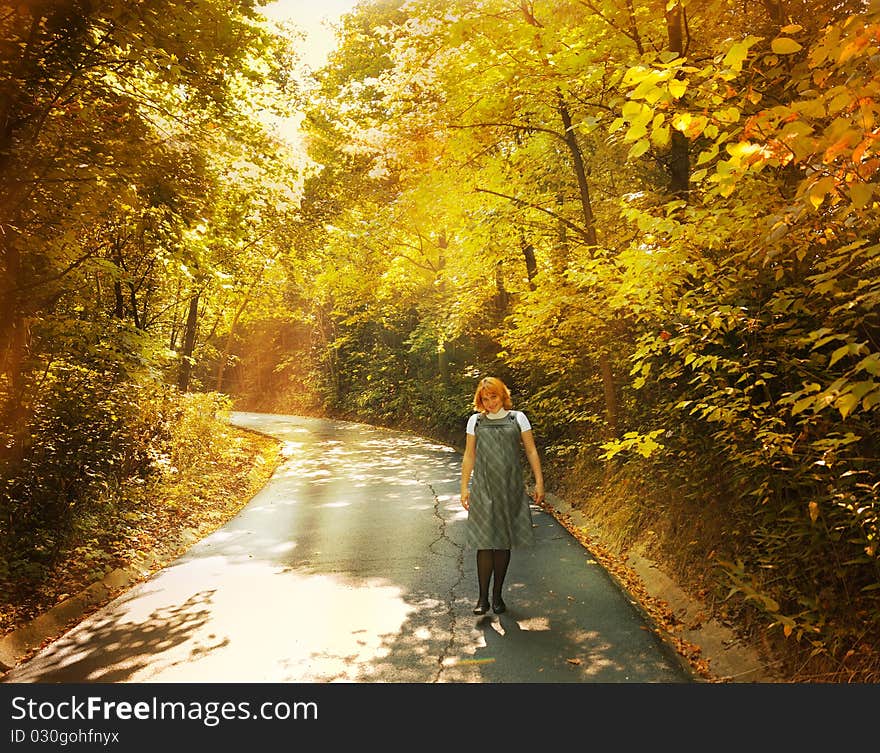 The pregnant woman walks on autumn park