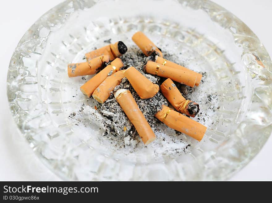 Close view of an ashtray filled with cigarette butts. Close view of an ashtray filled with cigarette butts.