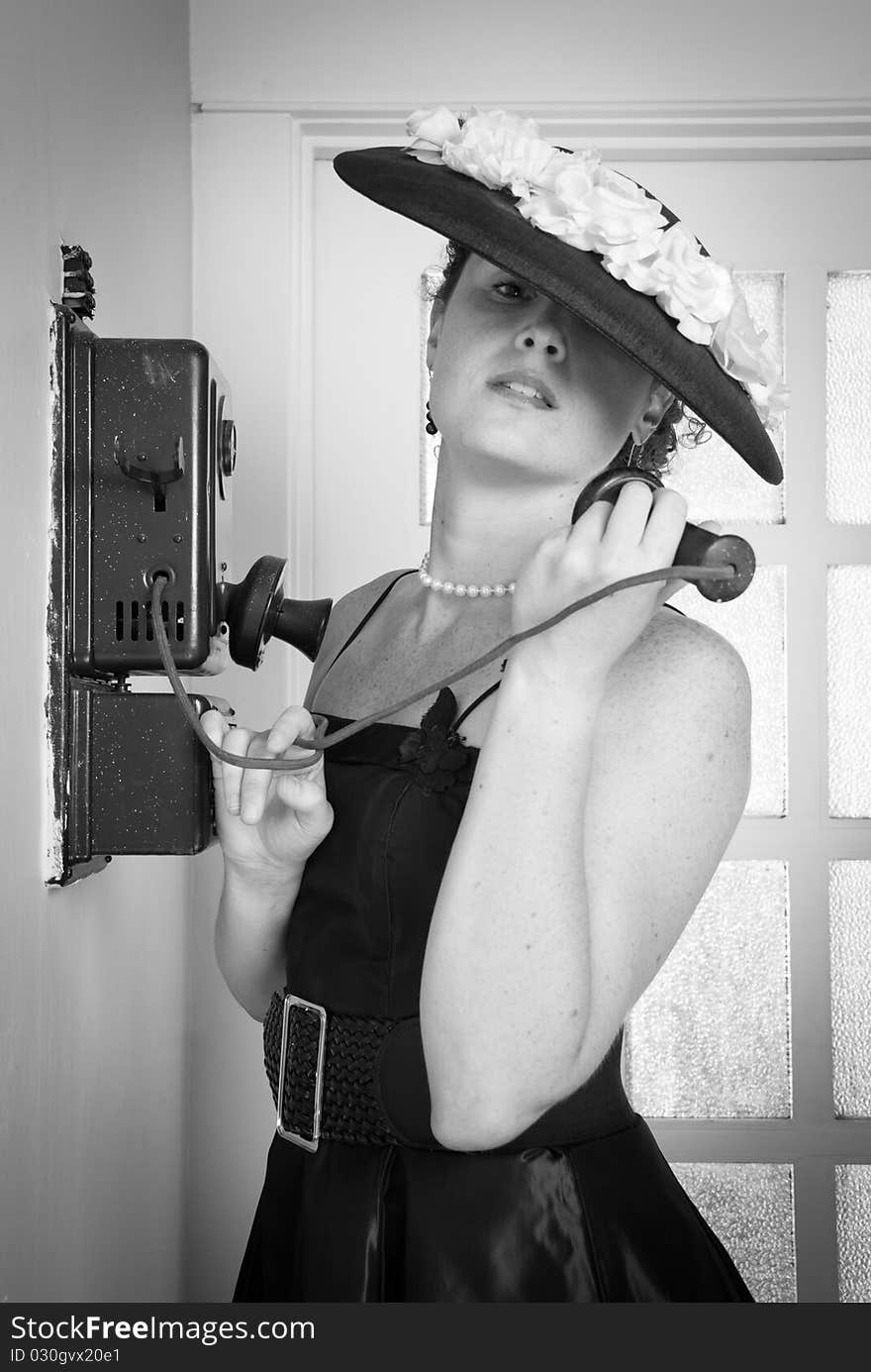 Beautiful vintage style woman calls on an antique phone. Beautiful vintage style woman calls on an antique phone