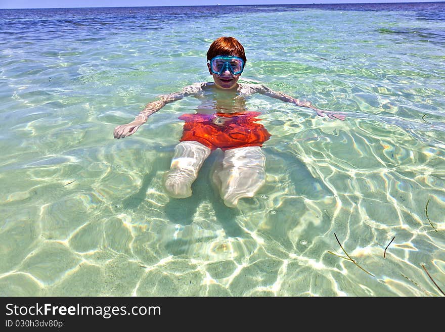 Boy with red hair loves to dive in the ocean. Boy with red hair loves to dive in the ocean