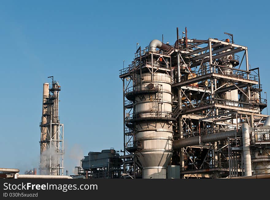 A petrochemical refinery plant with pipes and cooling towers.