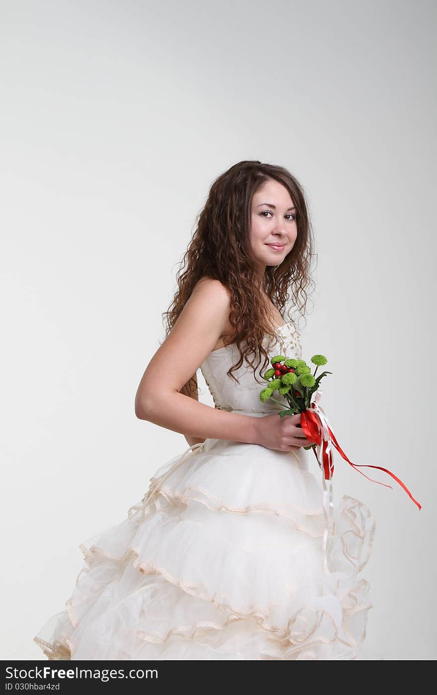 Smiling bride in wedding dress with bouquet