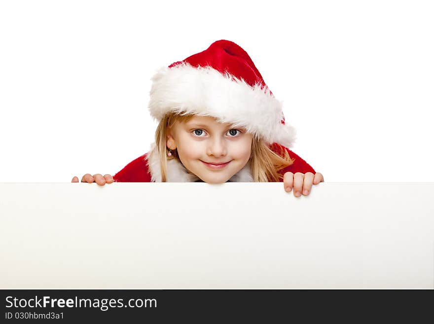 Small girl dressed as santa claus holds blank advertisement sign. Isolated on white background. Small girl dressed as santa claus holds blank advertisement sign. Isolated on white background.