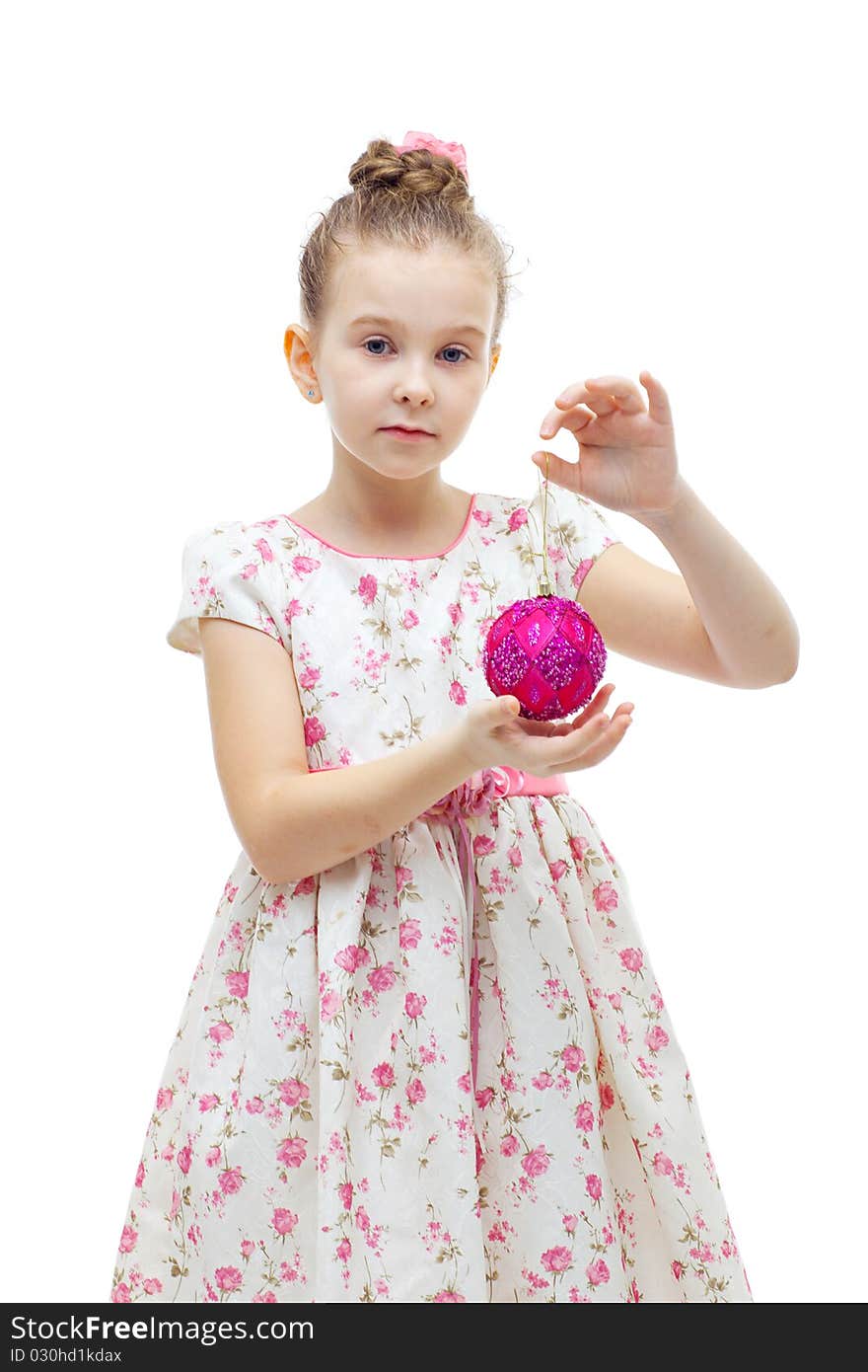 Cute little girl in dress playing with a christmas-tree decoration on white background isolated