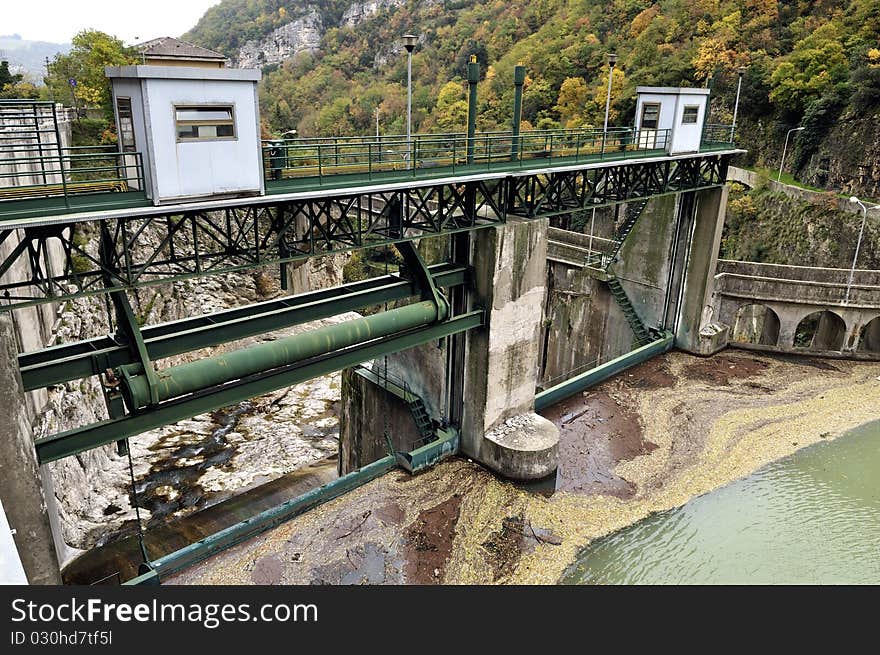 A dam with hydroelectric plant in a mountain river