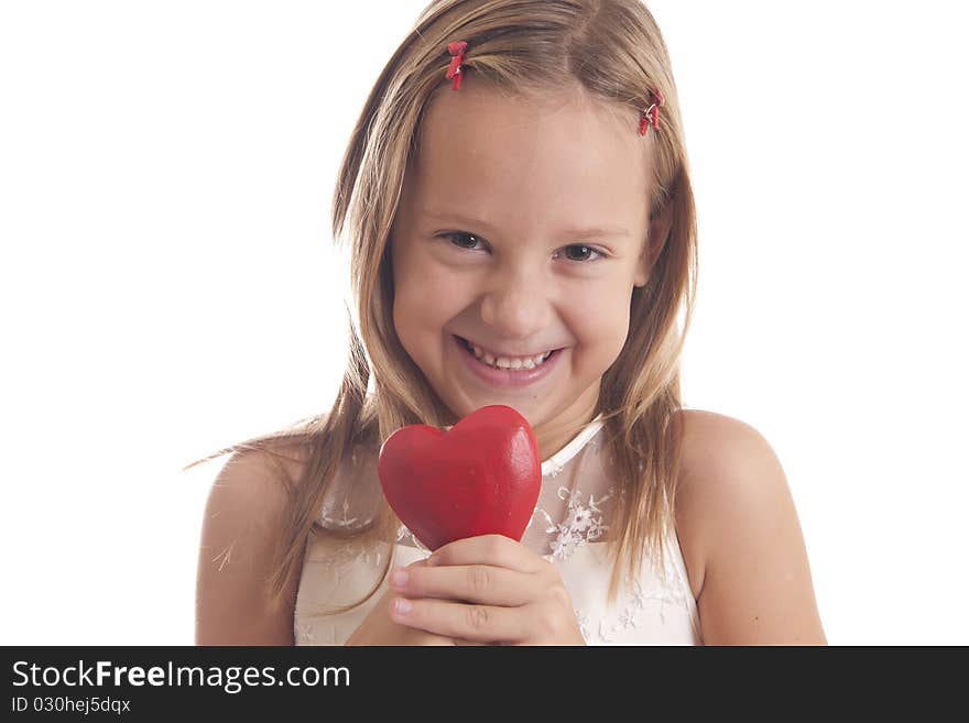 The girl holds one red heart and smiling on white background. The girl holds one red heart and smiling on white background