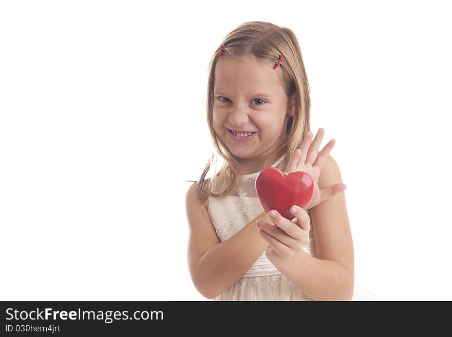 Girl holds re heart and screws up her face. Girl holds re heart and screws up her face