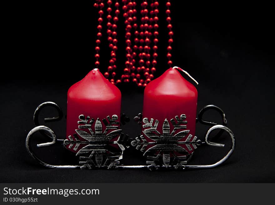 Christmas sledge with candles onto black background