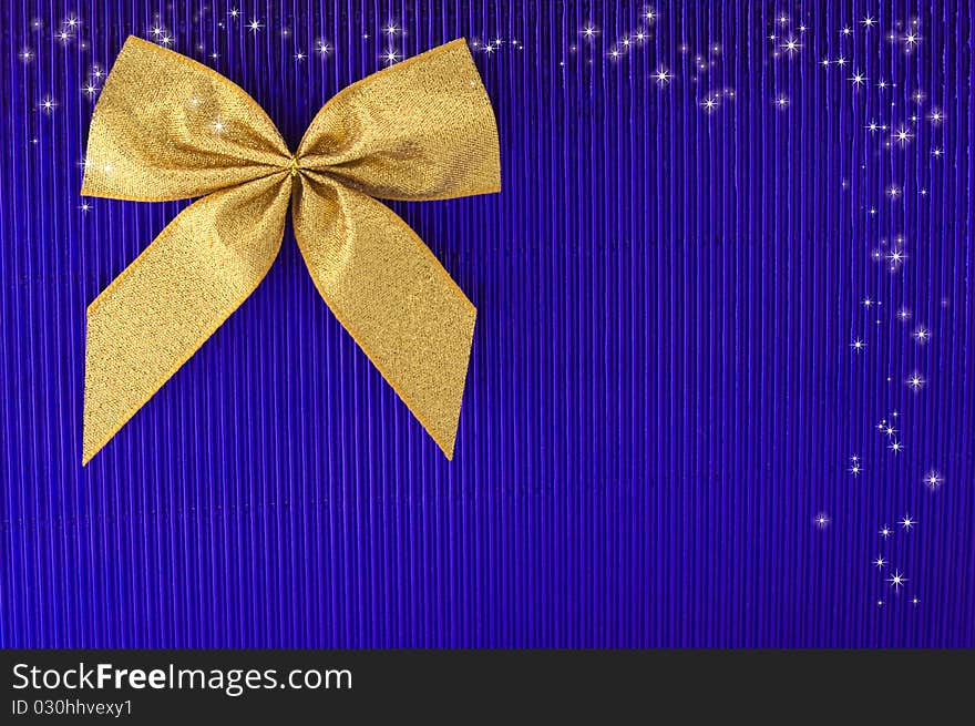 Gold bow on blue background. Gold bow on blue background.