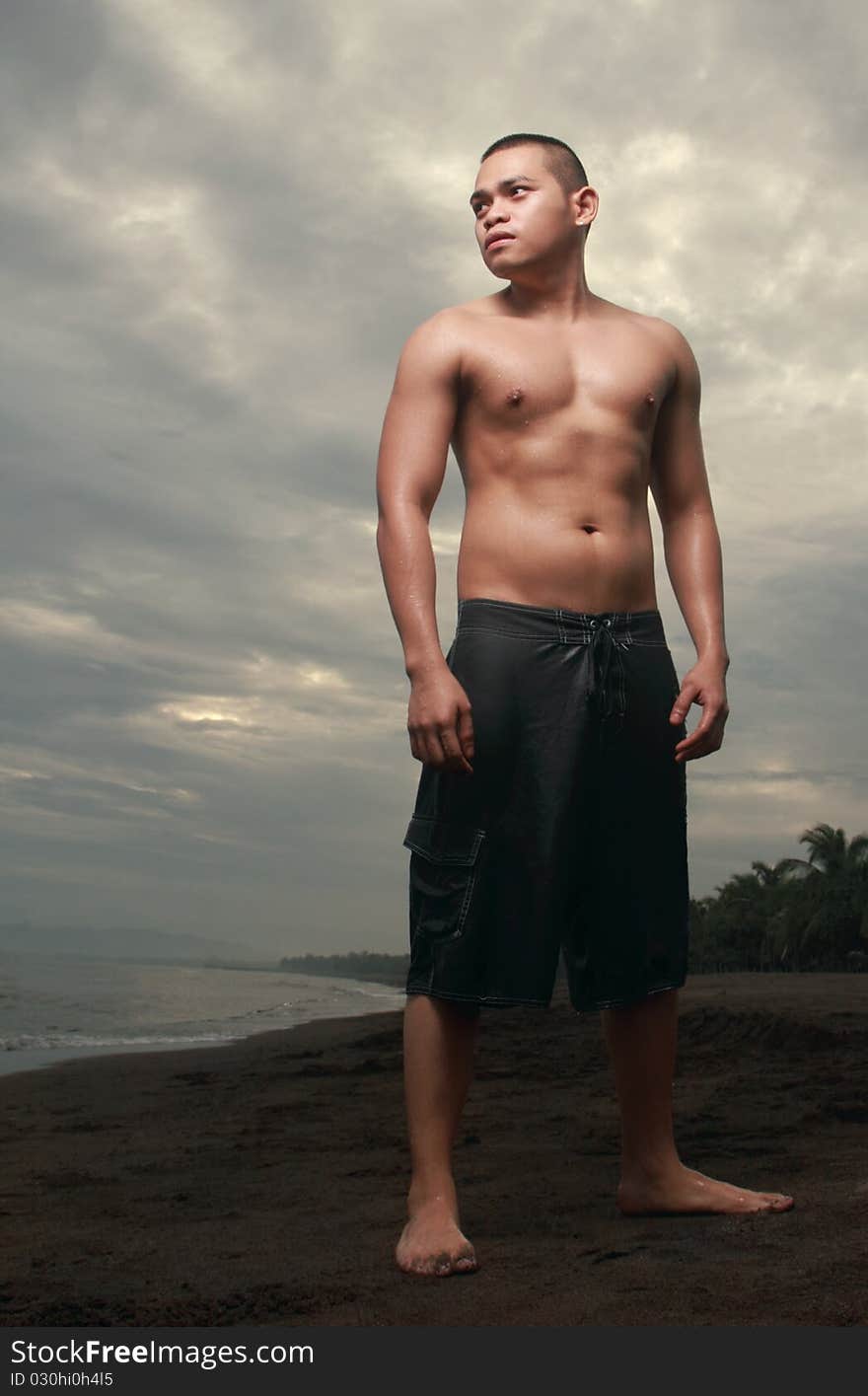 Asian man standing at the beach. Asian man standing at the beach