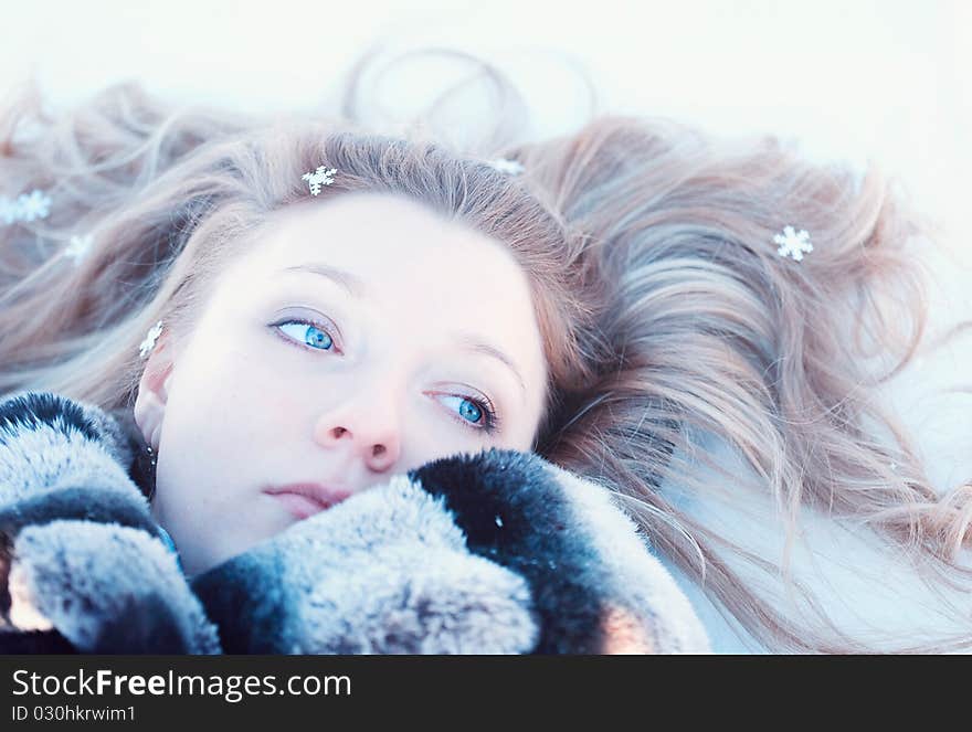 Winter girl with many snowflakes