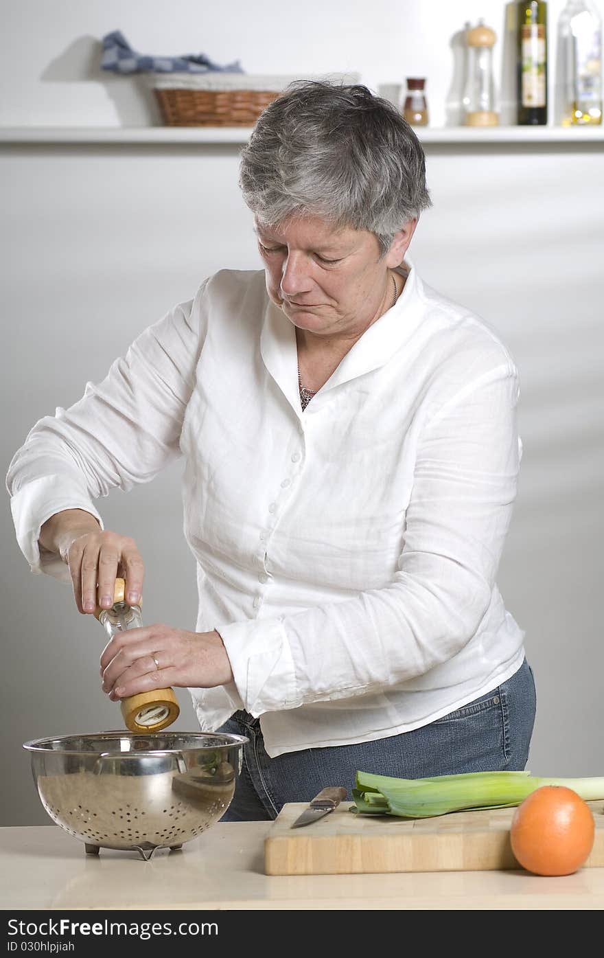 Women using a pepper mill