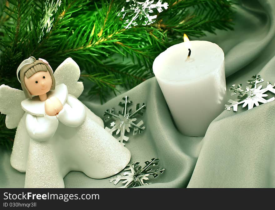 Christmas composition: Angel, a candle and a fur-tree branch. Christmas composition: Angel, a candle and a fur-tree branch