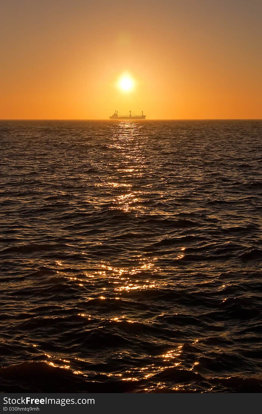 Sunrise in the sea. Ship on the background. Sunrise in the sea. Ship on the background.