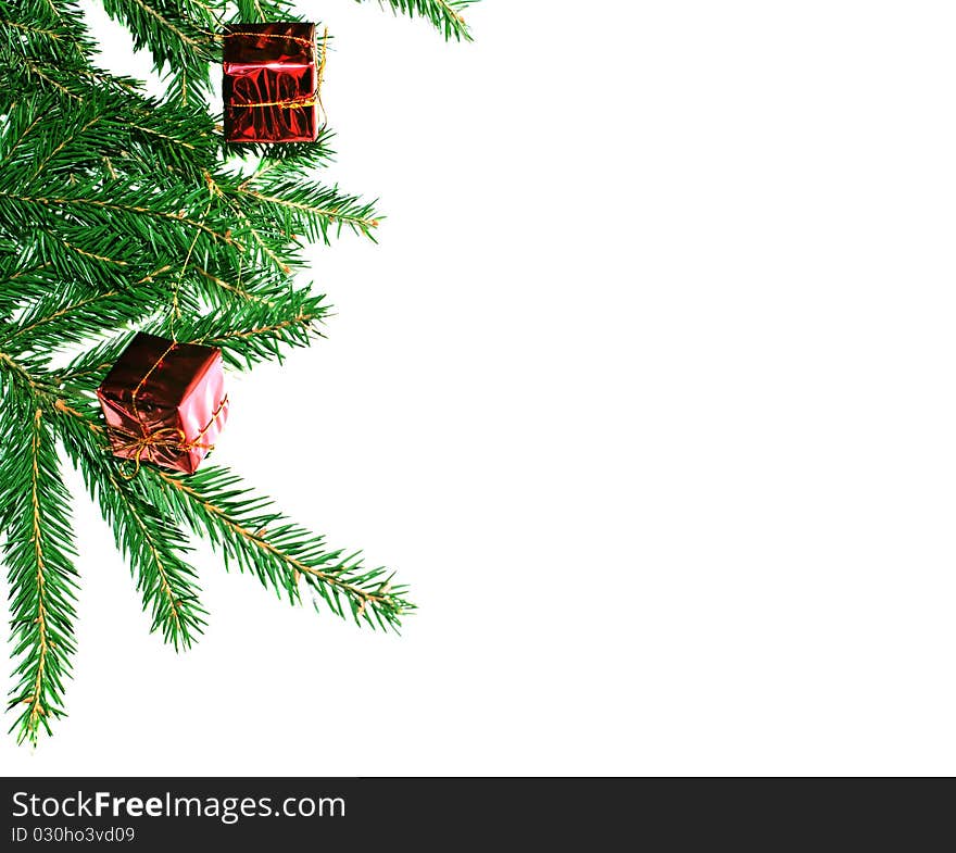 Fur-tree branch with small presents on a white background