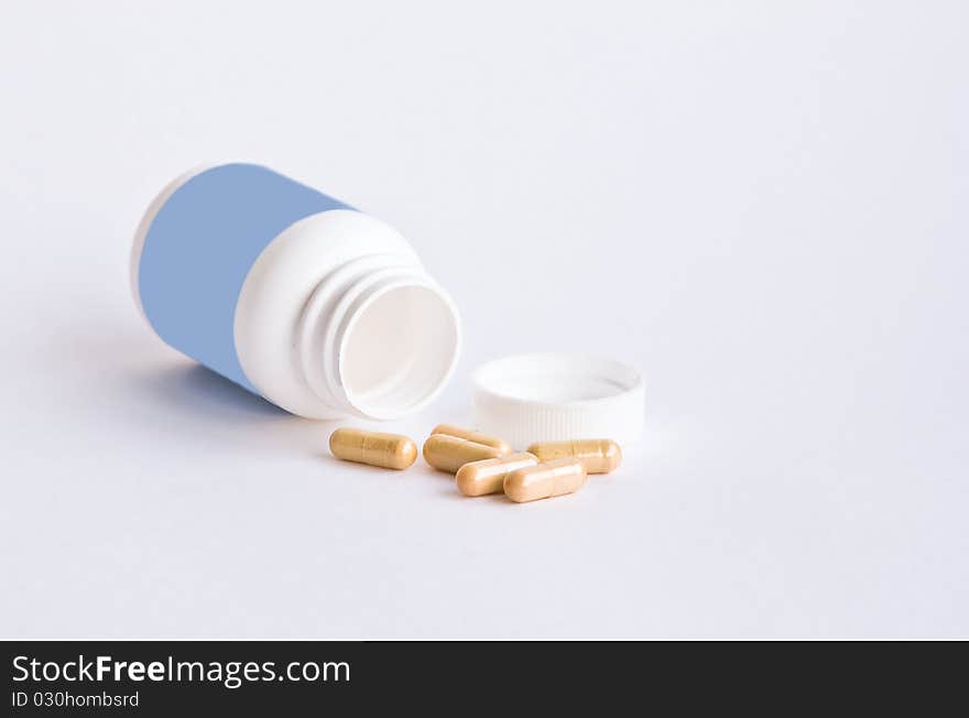 Medicinal pills and a jar with a white background