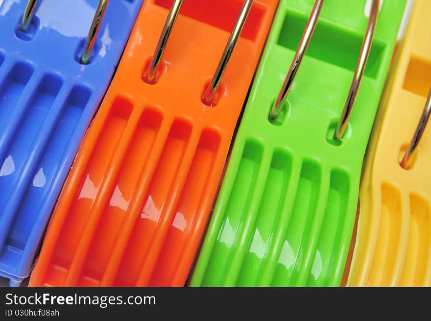 Close up of four colorful clothes pegs. Close up of four colorful clothes pegs