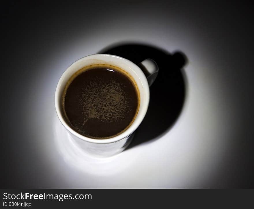 Black coffee in white cup on dark background