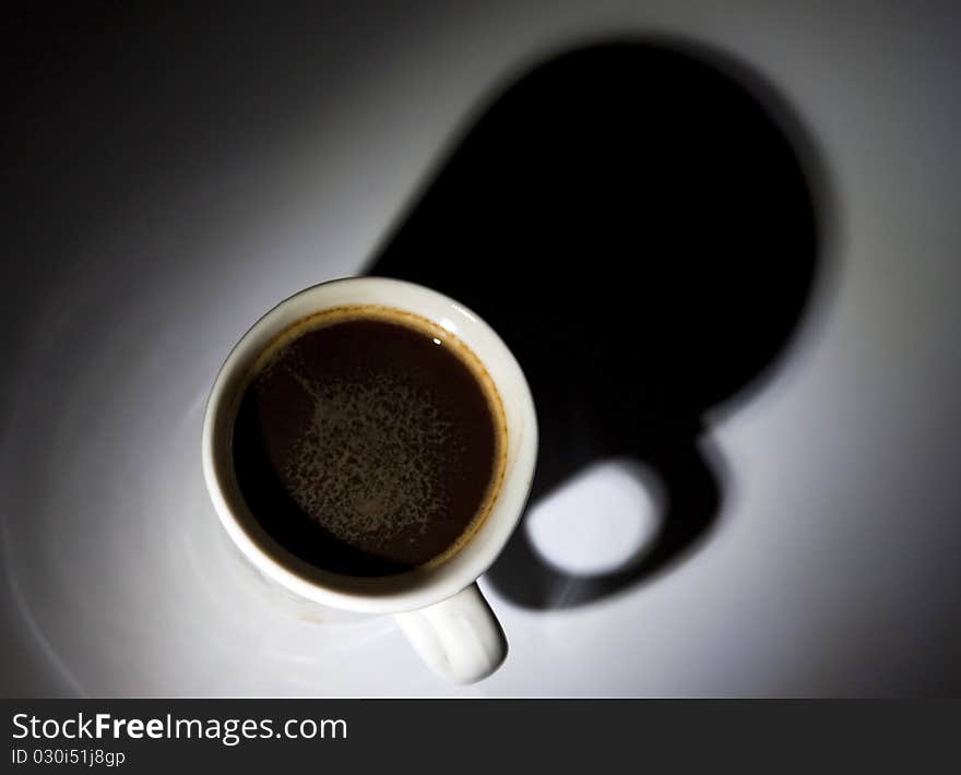 Black coffee in white cup on dark background