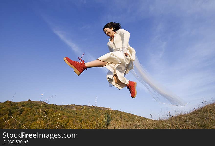 Happy Bride With Red Boots Jumping