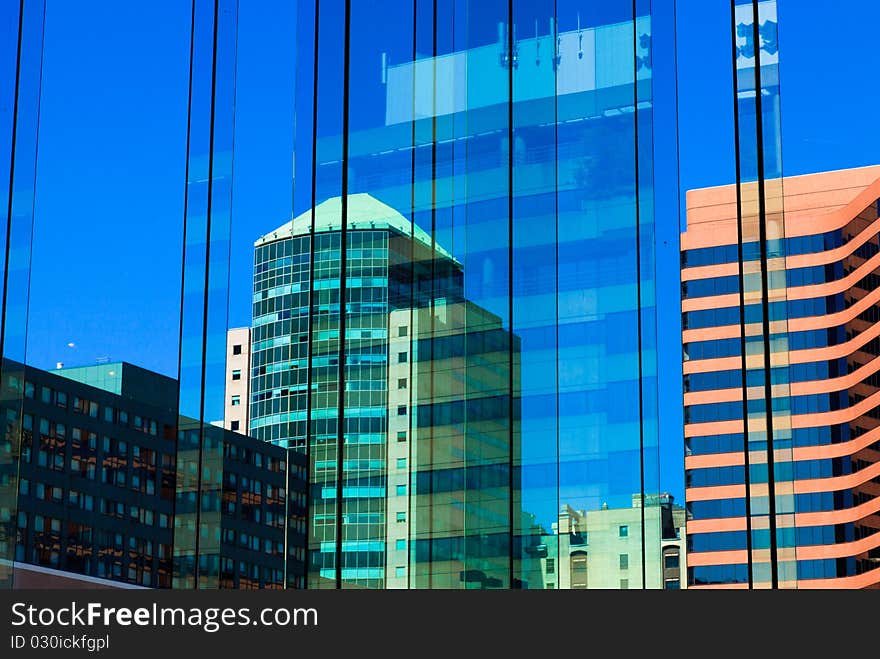 Skyscrapers, towers and reflection in the glass on blue sky. Skyscrapers, towers and reflection in the glass on blue sky