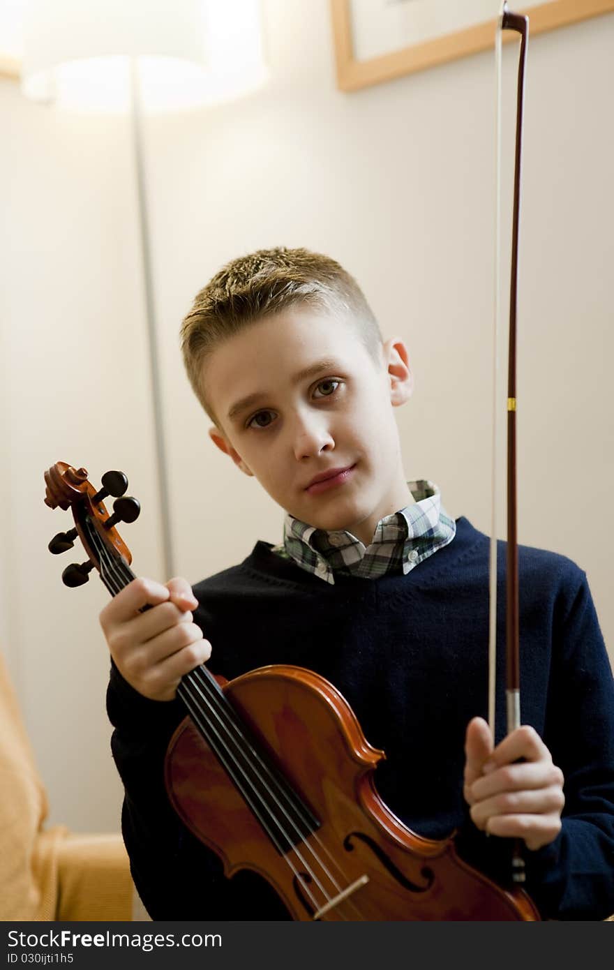 Young boy with his violin at home