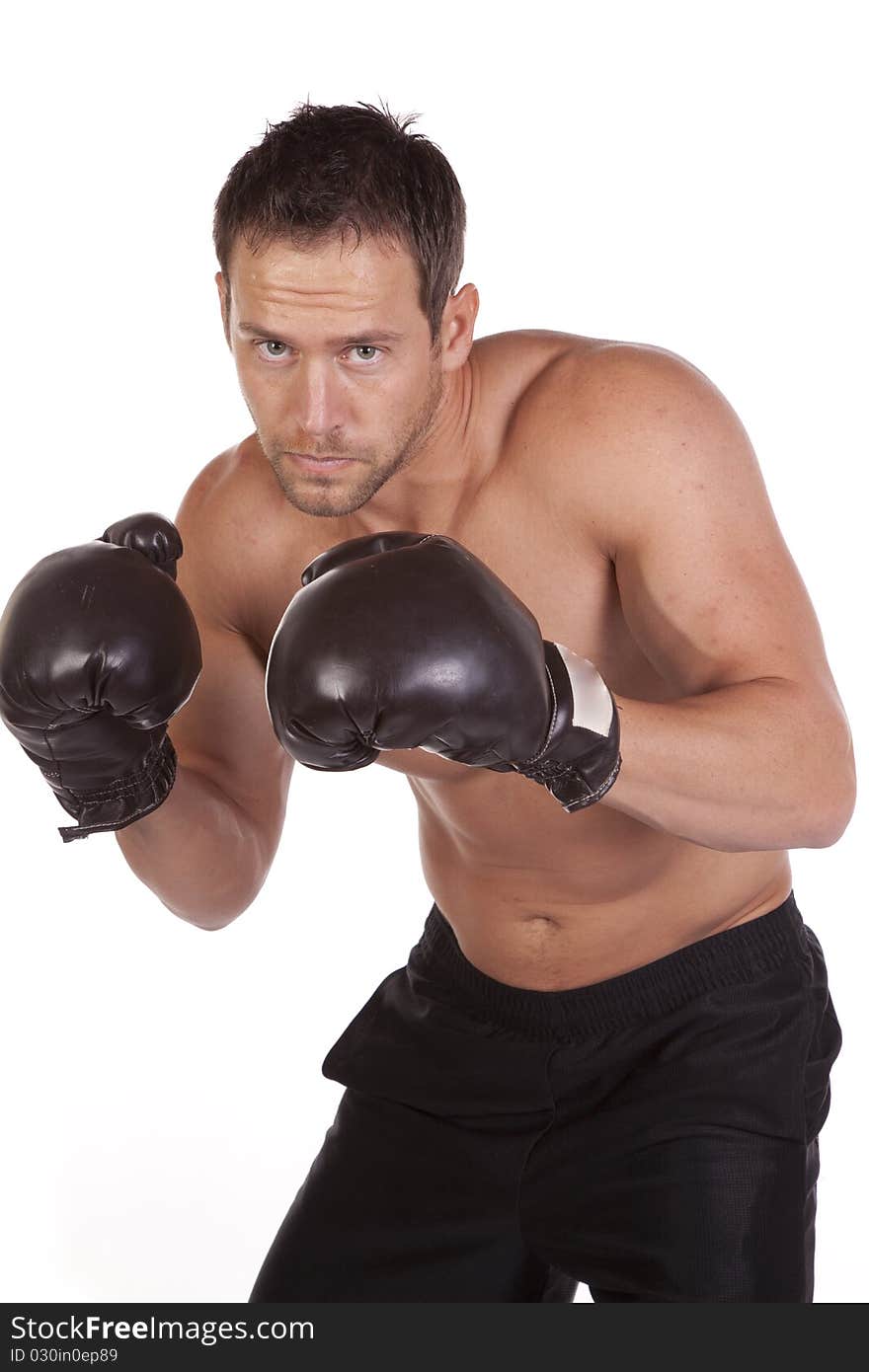 A close up of a man in boxing gloves with a serious expression on his face. A close up of a man in boxing gloves with a serious expression on his face.