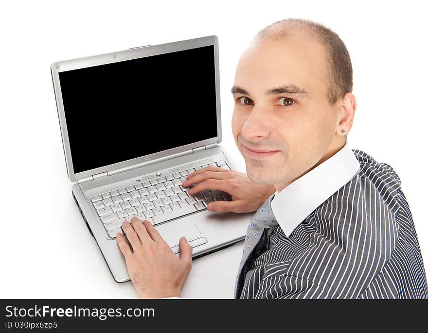 Portrait of a young businessman using laptop