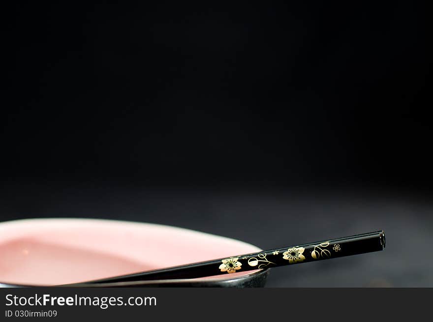 Japanese plate and Wood sticks on black background. Japanese plate and Wood sticks on black background.