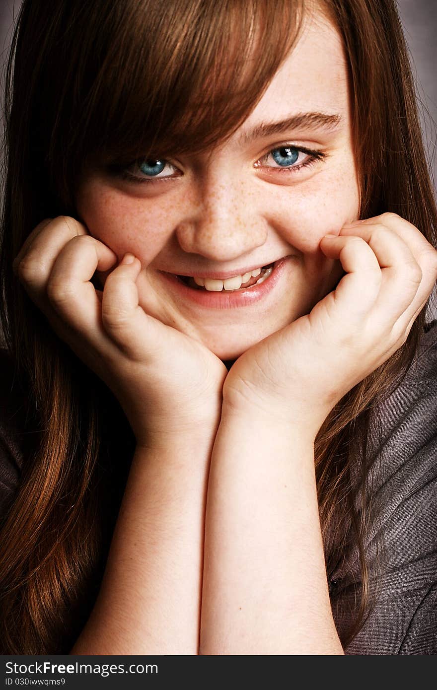 A beautiful young girl smiling to the camera. A beautiful young girl smiling to the camera.