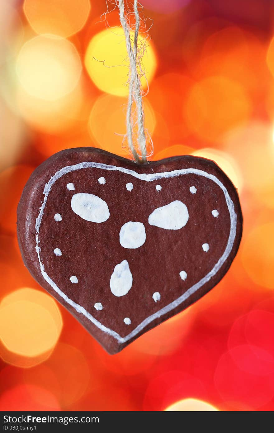 Gingerbread cookies heart decoration against blurred background. Gingerbread cookies heart decoration against blurred background