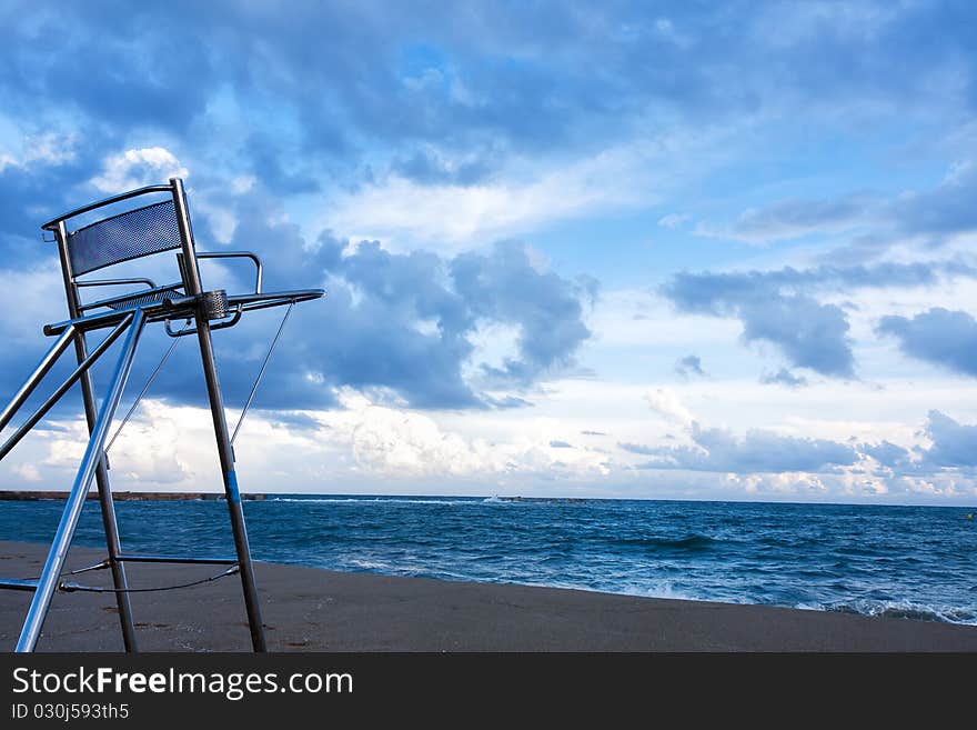 Empty beach and  empty  lifesaver chair