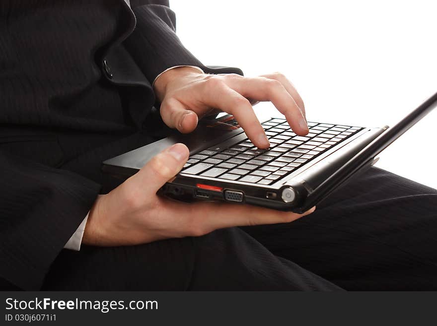 The man working on a laptop on the white background.