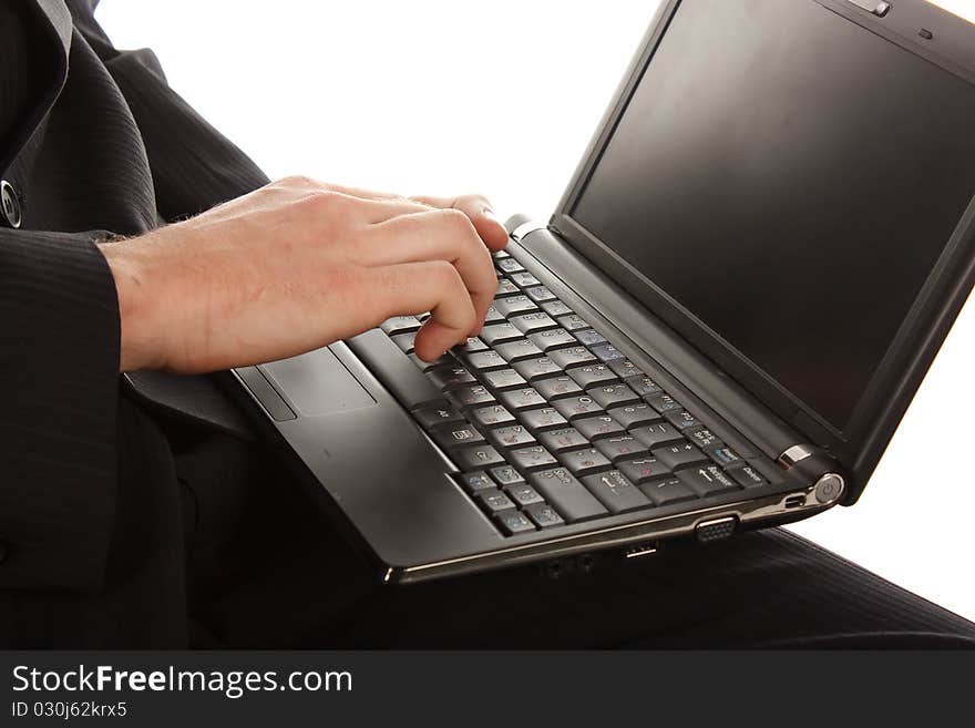 The man working on a laptop on the white background.