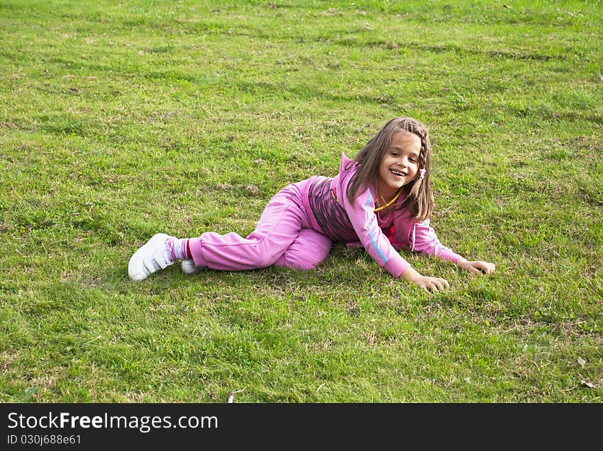 Little girl enjoy playing on grass. Little girl enjoy playing on grass