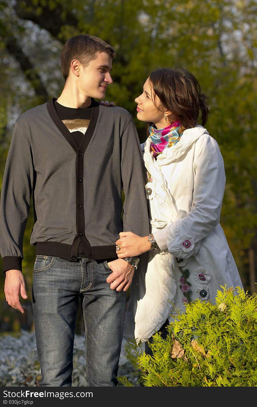 Young couple looking at each other eyes over defocused background. Young couple looking at each other eyes over defocused background