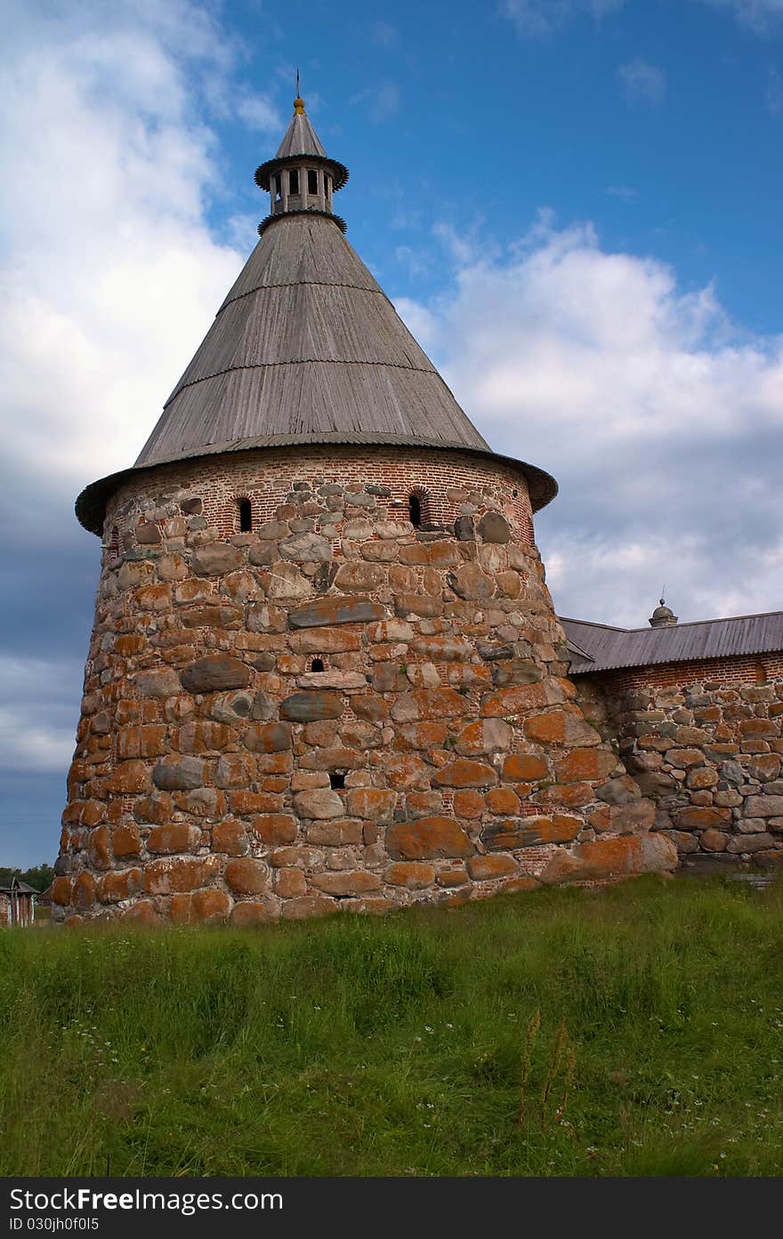 Old round stone tower in Solovetsky monastery with blue sky background, Karelia, Russian Federation. Old round stone tower in Solovetsky monastery with blue sky background, Karelia, Russian Federation.